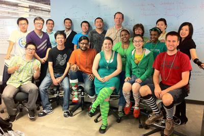 <p>Group photo of BBISS students and staff wearing St. Patrick's Day regalia, mostly goofy socks.</p>