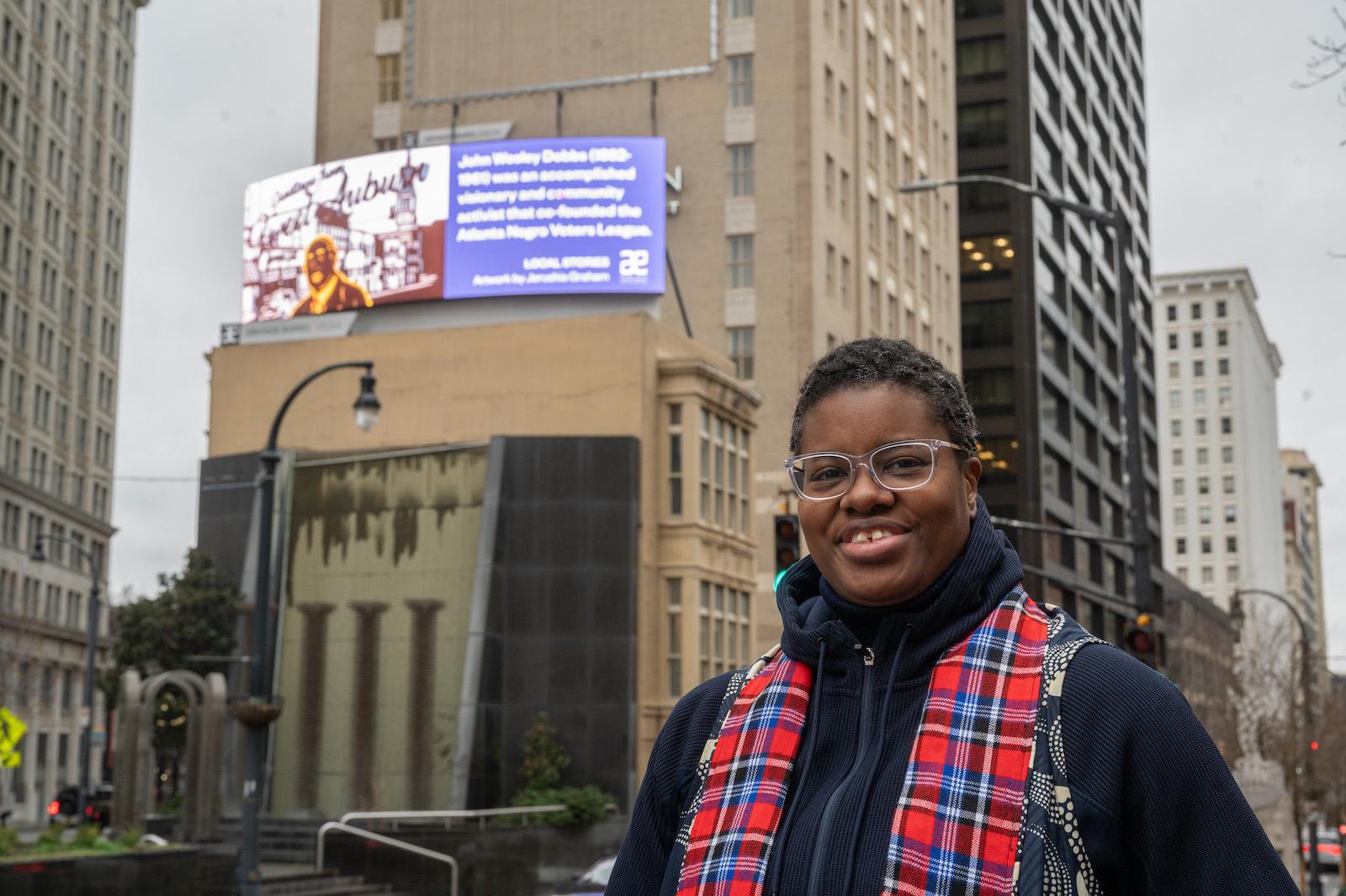 Jerushia Graham in front of her digital billboard in downtown Atlanta. 