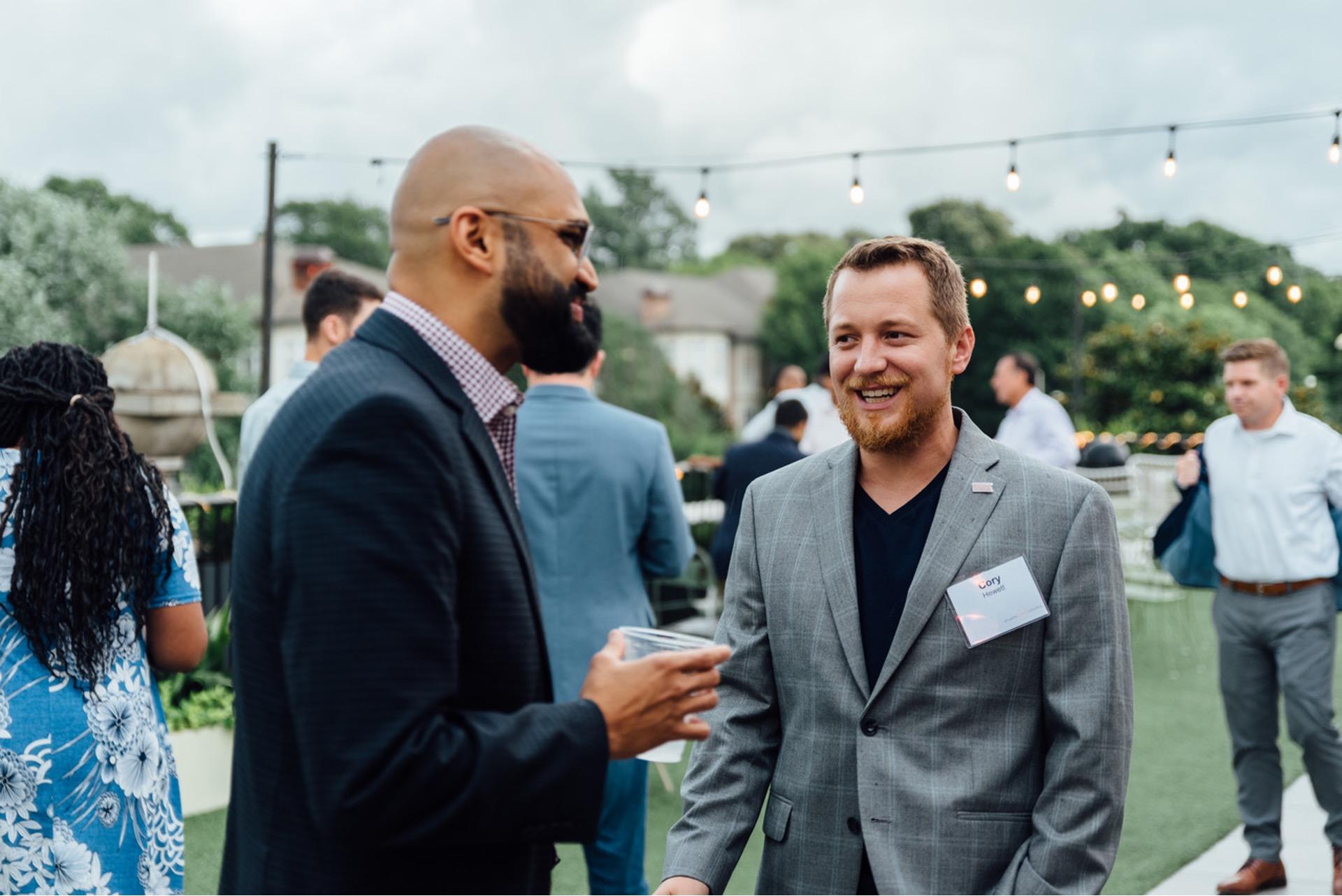 Corey Hewitt, cofounder of Gimme Vending, laughs as he mingles at an outdoor event. 