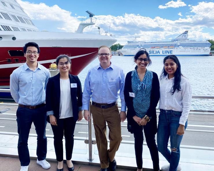 <p>Carson Meredith standing outside in Finland with Georgia Tech Ph.D. students: Yue Ji (ChBE), Li Zhang (MSE), Nasreen Khan (ChBE), and Udita Ringania (ChBE).</p>