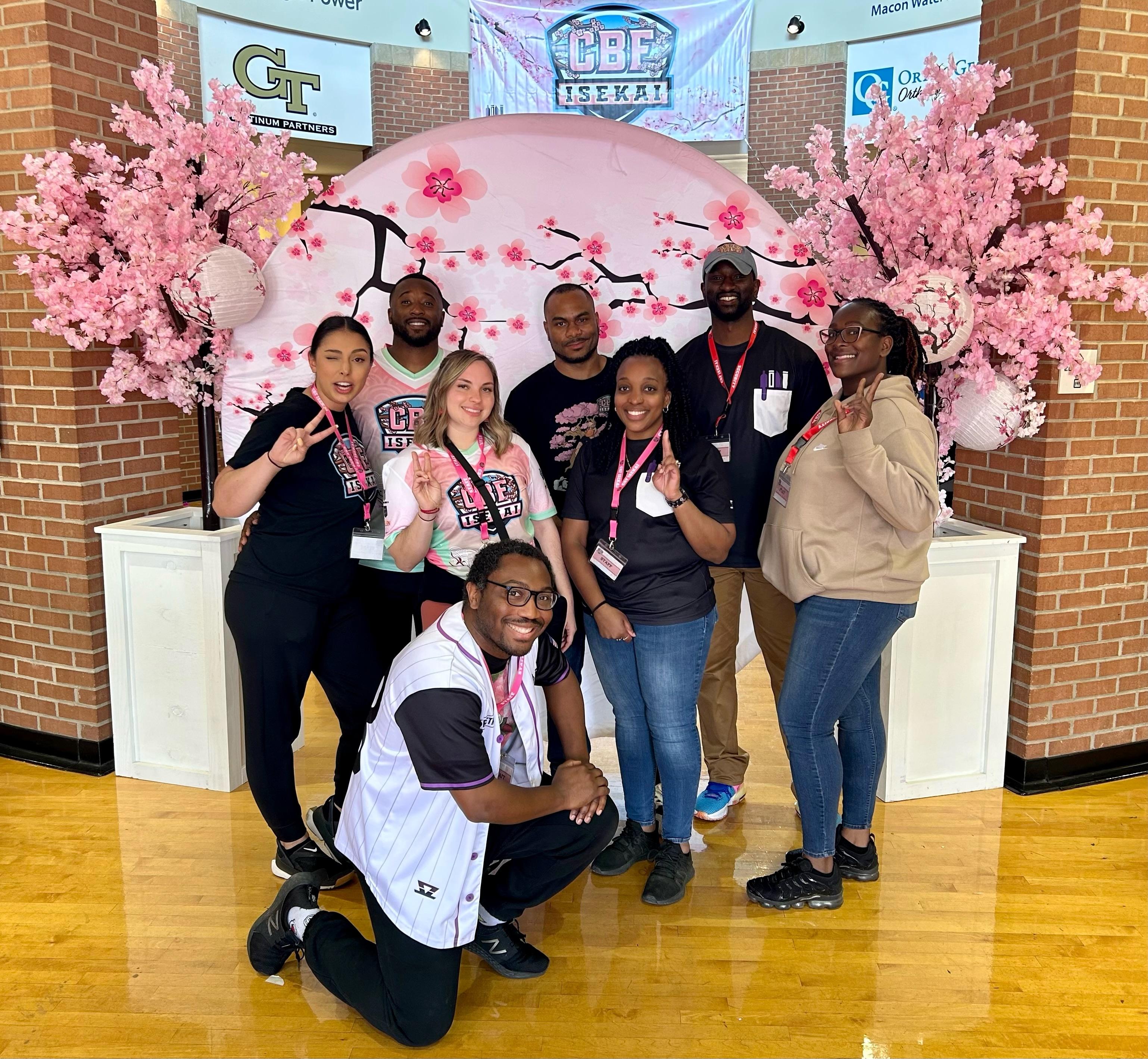 Group of people posing at competition.