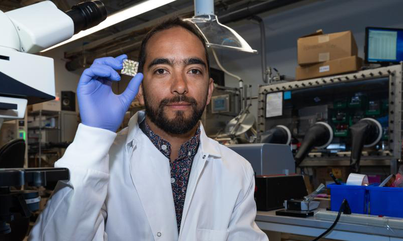 JuanpBablo CIrrea-Baena in a lab holding a chip