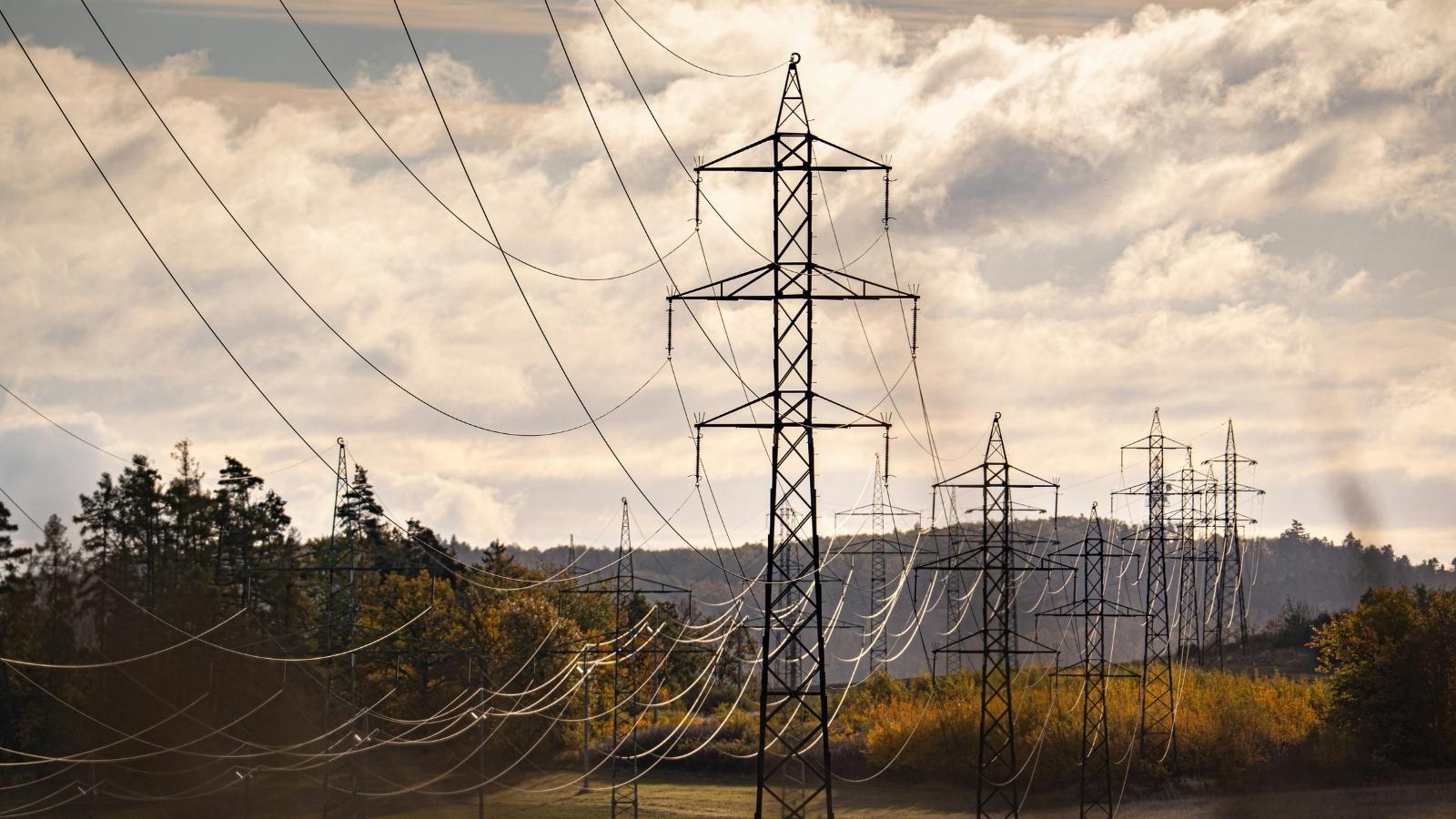 Power lines running through open land.