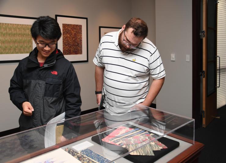 <p>Papermaking Museum: RBI Fellows Xirui Peng, ME, and Daniel Kimmel, ME, view papers on display during the opening of 'Marvelous Marbling: Demystifying Marbled Papers'</p>