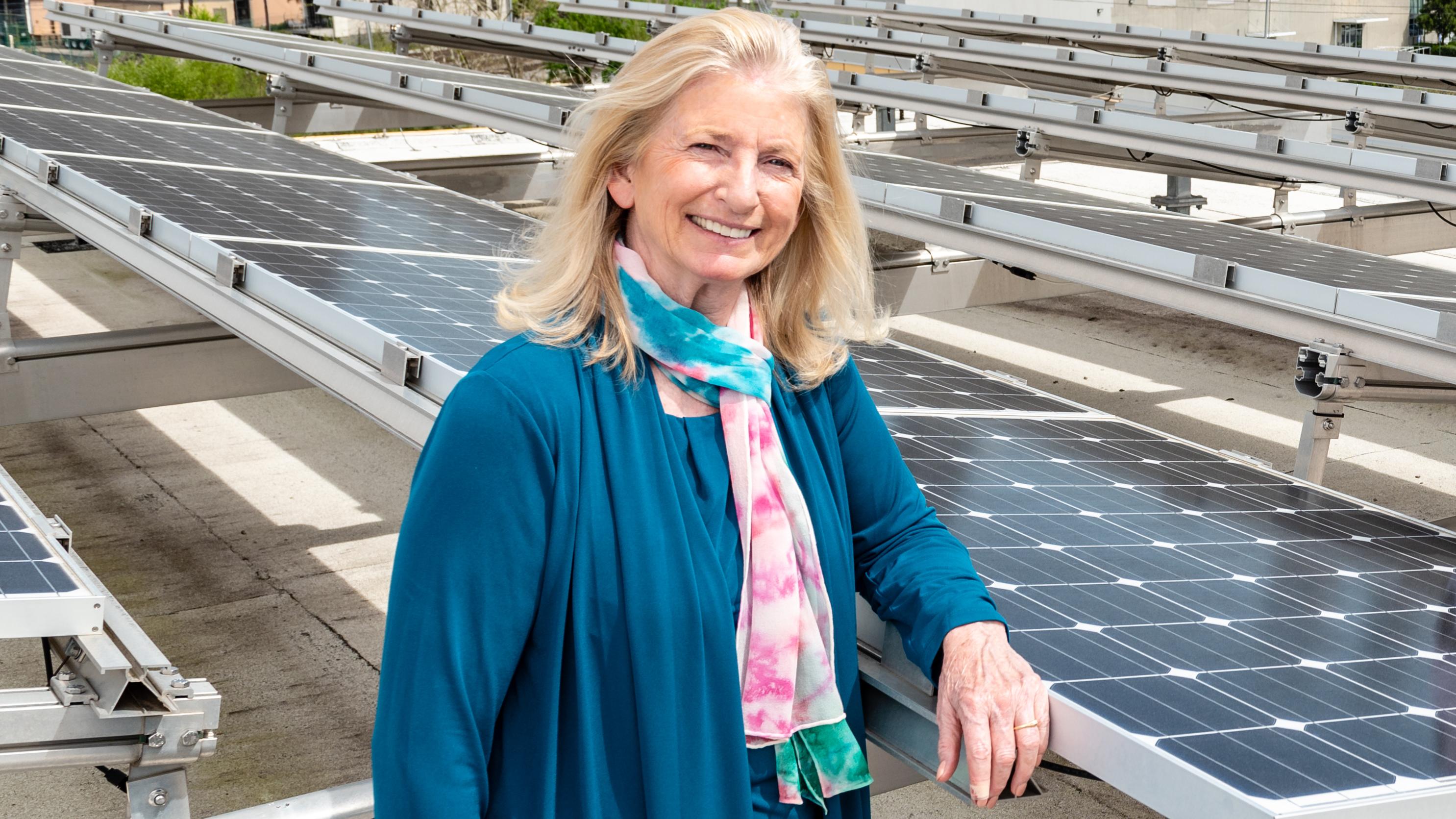 Regents' Professor Marilyn Brown stands among solar panels