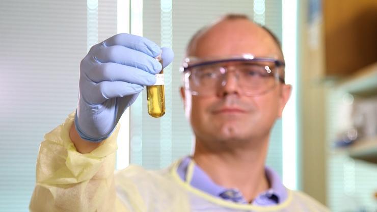 <p>Researcher Roman Mezencev holds a sample of nanohydrogel developed for targeted delivery of siRNA to cancer cells and successfully tested in vivo in mice in John McDonald's Georgia Tech lab. Credit: Georgia Tech / Micah Eavenson / Adam Karcz</p>