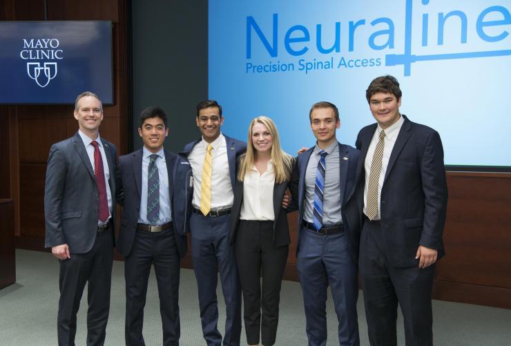 <p>Team Neuraline and Dr. Rains: Pictured are (left to right), Professor of the Practice James Rains, and Capstone students Cassidy Wang, Dev Mandavia, Marci Medford, Lucas Muller, and Alex Bills. They visited the Mayo Clinic in Jacksonville, Florida, to make their Capstone presentation.</p>