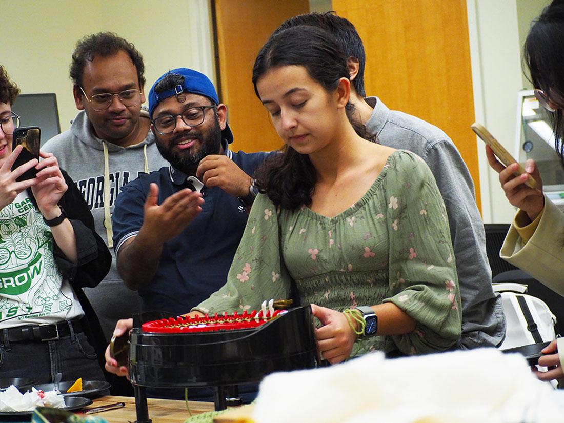 Foley Scholar MS Arianna Mastali (MS-HCI) demonstrates the use of the Craft Lab knitting machine. 