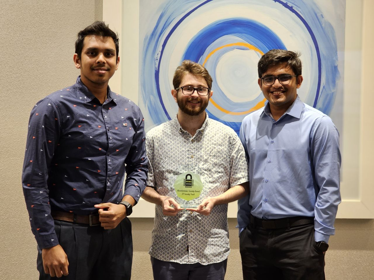 Photo of Mahmudul Hasan (KU), Zachary Ellis (GT), and Tanvir Hossain (KU) holding their award for winning this year's Microelectronics Security Award (IP Security Track) at the IEEE International Symposium on Hardware Oriented Security and Trust (HOST). Not pictured is team Georgia Tech team member Anupam Golder. 