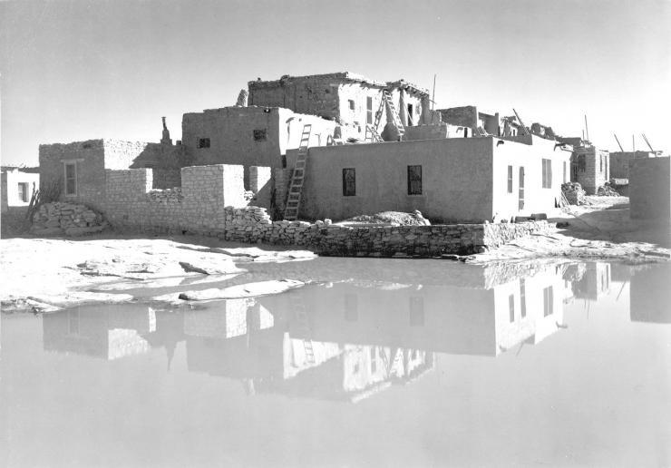 <p>Full Side View of Adobe House with Water in Foreground, Acoma Pueblo [National Historic Landmark, New Mexico]. Credit: National Archives/Ansel Adams/public domain</p>