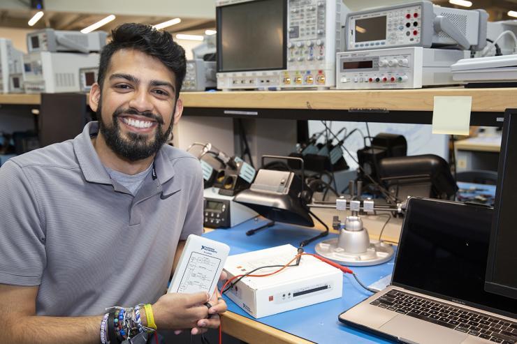 <p>Rohan Sohani, the current president of Tech’s Student Government Association, displaying a myDAQ instrumentation device. Starting in the Fall 2022 semester, all Georgia Tech students will be able to check out a myDAQ from the library — saving many upwards of $300 on the required piece of equipment for some ECE courses.</p>