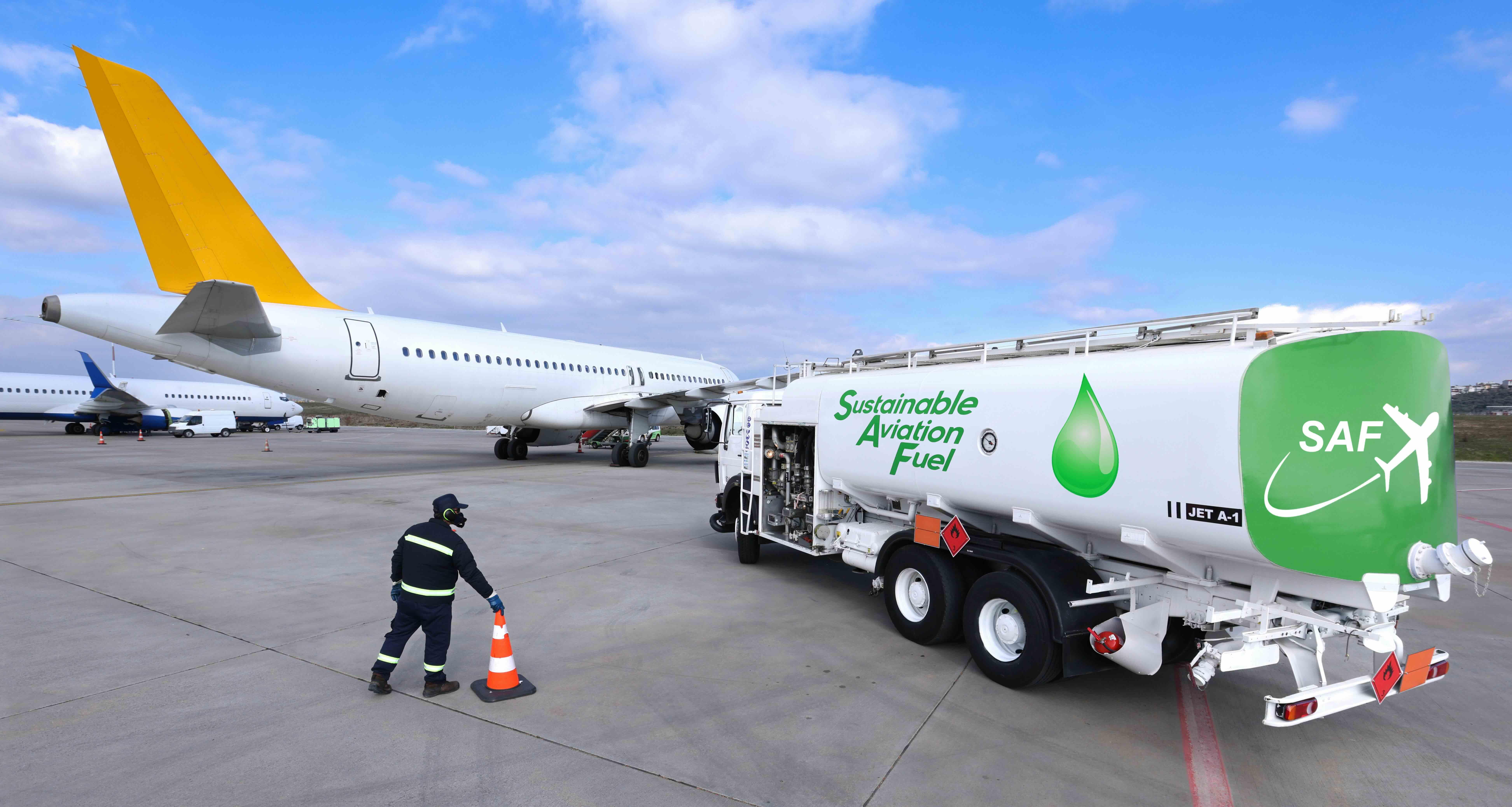 Fuel Truck carrying Sustainable Aviation Fuel near an airplane