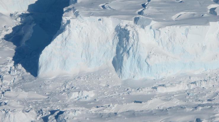 <p>Thwaites Glacier's outer edge. As the glacier flows into the ocean, it becomes sea ice and drives up sea-level. Thwaites Glacier's ice is flowing particularly fast, and some researchers believe it may have already tipped into instability or be near that point, though this has not yet been established. Credit: NASA/James Yungel</p>