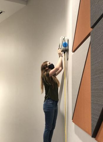 <p>ChBE PhD student Sabrina Westgate installs an air sensor to monitor classroom air quality.</p>