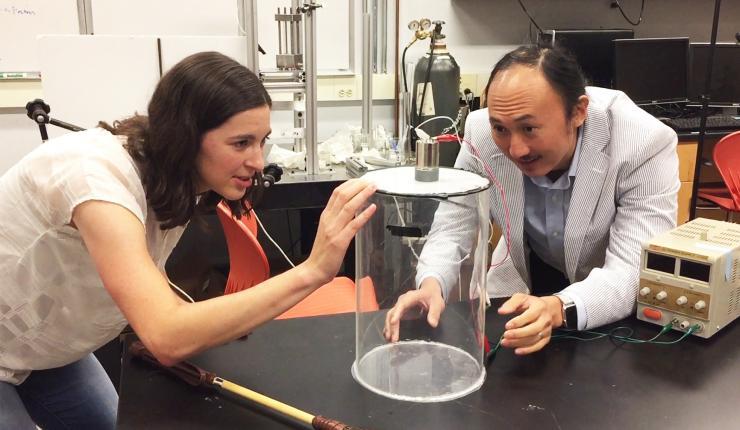 <p>Marguerite Matherne, a mechanical engineering Ph.D. student, and Professor David Hu examine the mammal tail simulator used to study the airflow needed to keep mosquitoes from landing. (Credit: John Toon, Georgia Tech)</p>