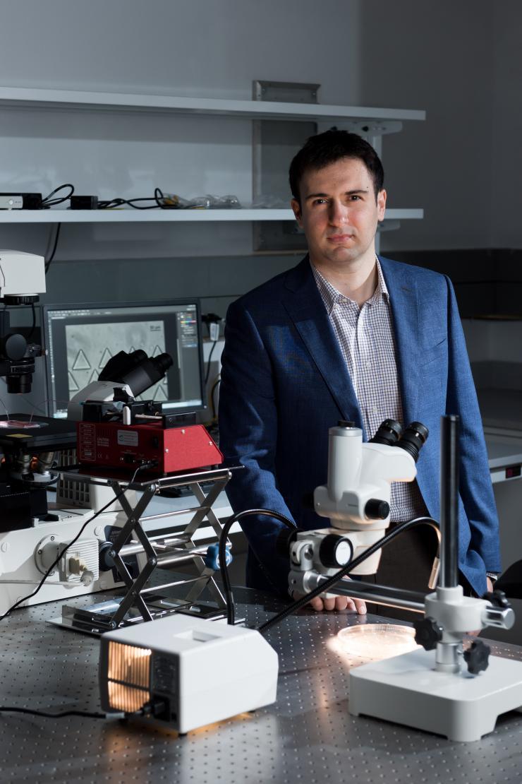 Fatih Sarioglu, an assistant professor in the Georgia Tech School of Electrical and Computer Engineering, is shown in his laboratory, where microfluidic devices are fabricated and tested. (Credit: Rob Felt)