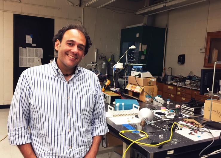 <p>Researchers now believe they understand why oversized microgel particles spontaneously shrink to allow formation of colloidal crystals in assemblies of smaller microparticles. Shown in a laboratory used to study the particles is Georgia Tech Associate Professor Alberto Fernandez-Nieves. (Credit: John Toon, Georgia Tech)</p>