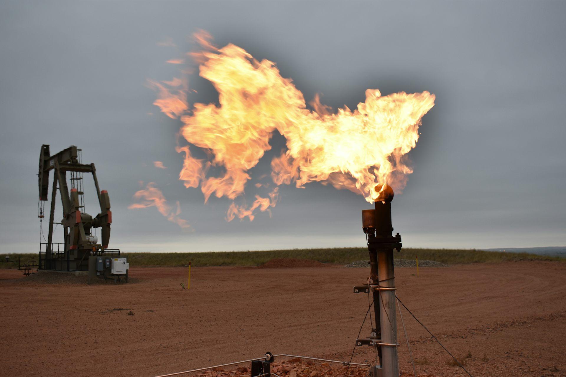 A flare burns natural gas at an oil well on Aug. 26, 2021, in Watford City, N.D. 