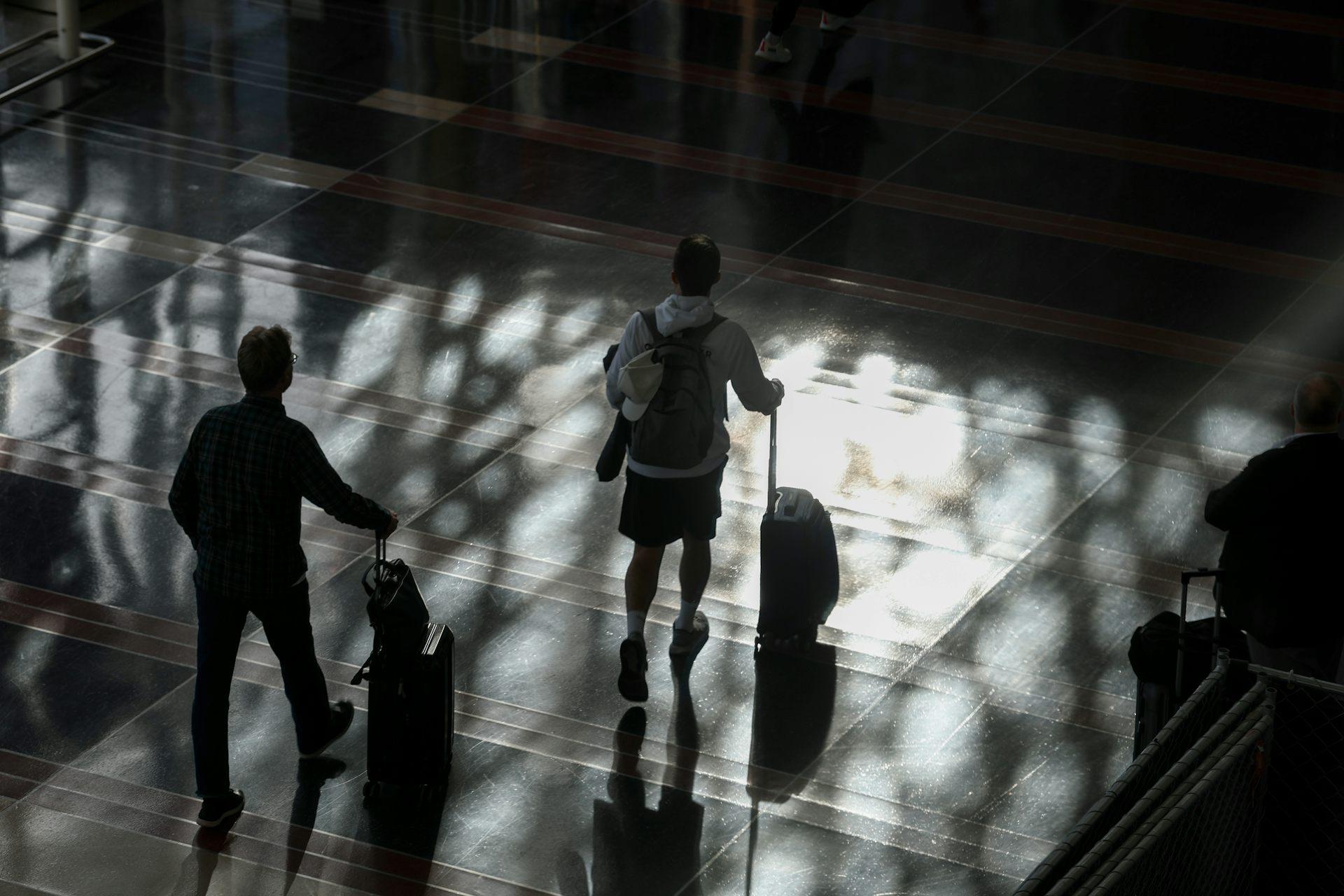 Passengers walk through the Ronald Reagan Washington National Airport on Nov. 7, 2025. Anna Moneymaker/Getty Images