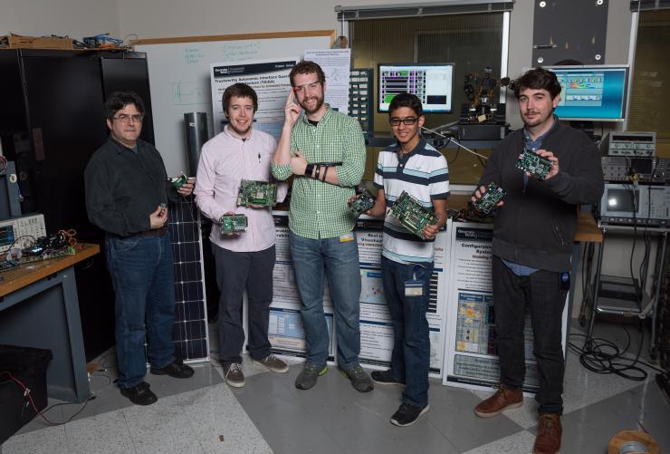 <p>Researchers Ron J. Prado, Zane R. Franklin, Jay Danner, Naman Shah, and Lee W. Lerner (left to right) demonstrate devices related to GTRI's work on security issues involving field programmable gate arrays (FPGAs). (Georgia Tech Photo: Rob Felt)</p>