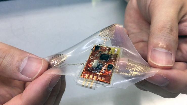 <p>A wireless, wearable monitor built with stretchable electronics could allow comfortable, long-term health monitoring of adults, babies and small children. (Photo: John Toon, Georgia Tech)</p>