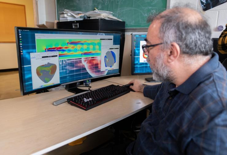 <p>Flavio Fenton, a professor in the School of Physics at the Georgia Institute of Technology, examines cardiac and fluid flow simulations created on a system that uses graphics processing chips designed for gaming applications and software that runs on ordinary web browsers. (Photo: Allison Carter, Georgia Tech)</p>