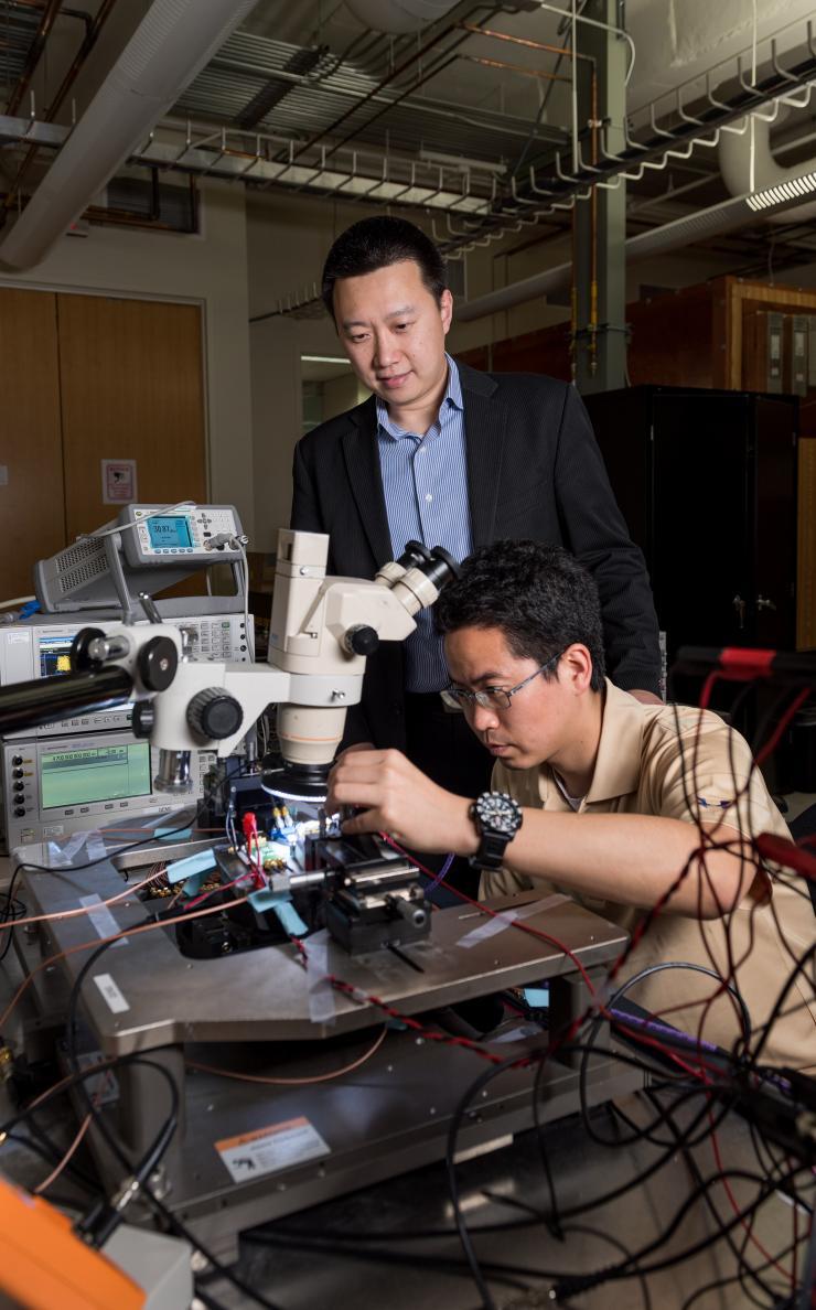 <p>Georgia Tech Ph.D. student Jong Seok Park (right) is performing electrical testing of the CMOS sensor chip with Assistant Professor Hua Wang (left). (Georgia Tech Photo: Rob Felt)</p>