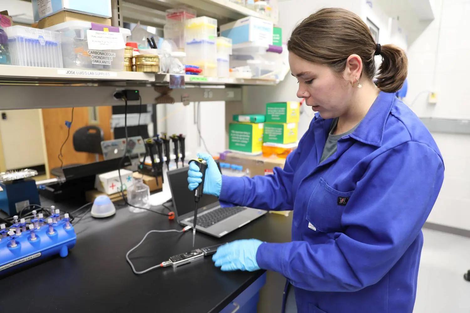 Georgia Tech Ph.D. student Jordan McKaig demonstrates how NASA astronauts onboard the International Space Station will use the MinION sequencing device to identify bacteria genomes. Credit: Georgia Tech