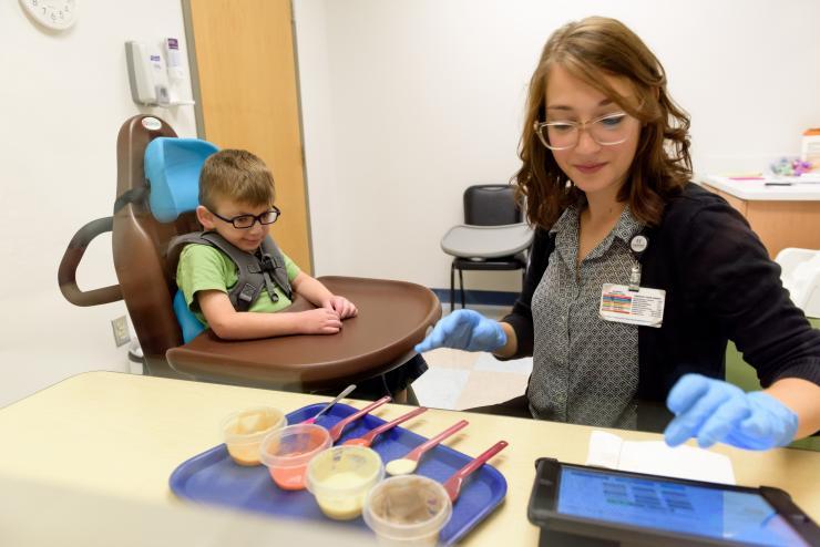<p>Technician Stefanie Jaskot uses the iEAT app as part of the Marcus Autism Center’s Feeding Disorder Program. The app was developed as part of the Quick Wins program, a project that came out of a collaboration with Children’s Healthcare of Atlanta. (Credit: Rob Felt, Georgia Tech)</p>