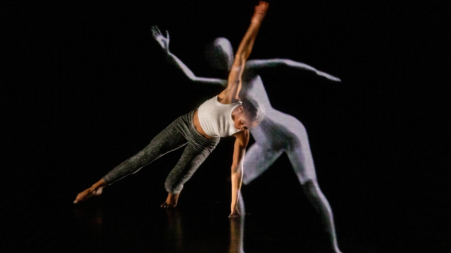 A Kennesaw State University dance student and the LuminAI-powered avatar dance together.