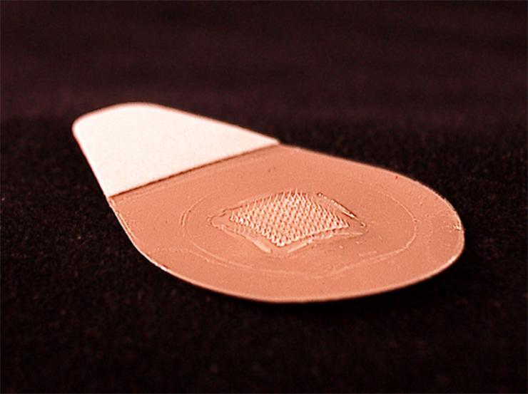 <p>This close-up image shows the microneedle vaccine patch, which contains tiny needles that dissolve into the skin, carrying vaccine. A majority of study participants said they would prefer to receive the influenza vaccine using patches rather than traditional hypodermic needles.</p>