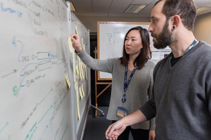 <p>GTRI Research Scientist Andew Baranak and Georgia Tech Graduate Student Rachel Chen discuss creating user interface workflows for the mission planning task. (Credit: Rob Felt, Georgia Tech)</p>