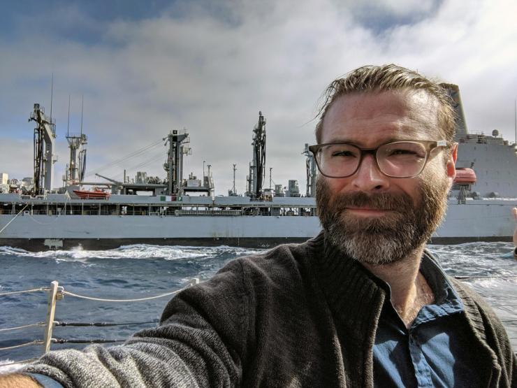 <p>A Shelby Allen selfie taken during resupply activities onboard the U.S.S. Rafael Peralta, a guided missile destroyer where GTRI researchers evaluated the Bifrost system. (Credit: Shelby Allen, GTRI)</p>