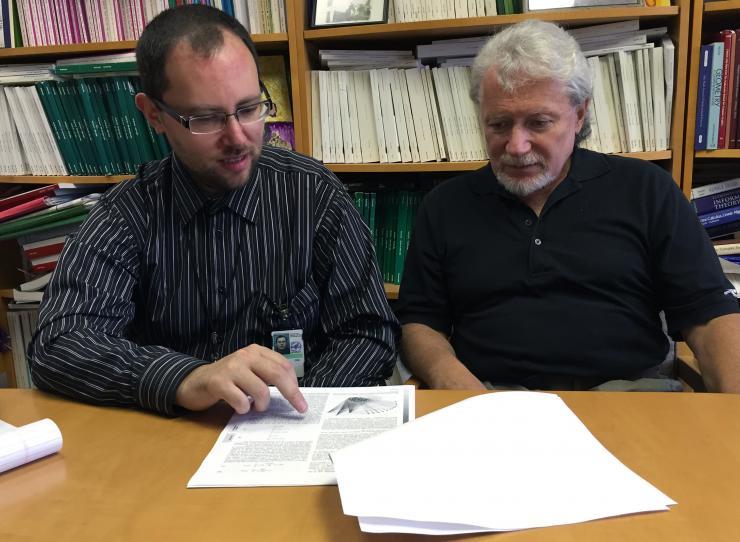 <p>Pavel Skums (left), a regular fellow with the Centers for Disease Control and Prevention (CDC), and Leonid Bunimovich, a Regent’s Professor at the Georgia Institute of Technology, explain their new paper on Hepatitis C behavior. (Credit: John Toon)</p>