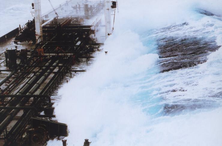 <p>A 60-foot rogue wave hits the OVERSEAS CHICAGO tanker as it was headed south from Valdez, Alaska in 1993. The ship was running in 25-foot seas when the monster wave hit it on the starboard side. (Credit: Captain Roger Wilson courtesy of NOAA)</p>