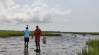 two people walking in flood water