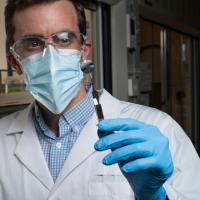 Georgia Tech Associate Professor Ryan Lively holding a small sample used to experimentally understand how the xylenes transport through the carbon structure. (Photo credit: Christopher Moore, Georgia Tech)