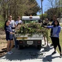 Volunteers from Students Organizing for Sustainability remove ivy from an area near The Kendeda Building for Innovative Sustainable Design in April 2022.