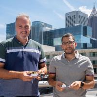 Samer Mabrouk and Omer Inan hold prototypes of their device.