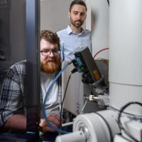 <p>Matthew Boebinger, a graduate student at Georgia Tech, and Matthew McDowell, an assistant professor in the George W. Woodruff School of Mechanical Engineering and the School of Materials Science and Engineering, used an electron microscope to observe chemical reactions. (Credit: Rob Felt)</p>
