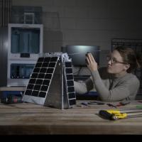 <p>Mary Kate Broadway adjusts the model's solar array. (photo: Sean McNeil)</p>
