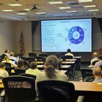 Speaker presenting at the Visions for Sustainable Polymers Symposium
