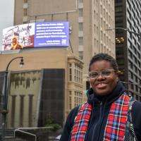 Jerushia Graham in front of her digital billboard in downtown Atlanta. 