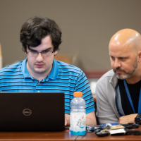 <p><em>Chris Roberts (right), a GTRI principal research engineer who leads CIPHER's Embedded Cyber Techniques branch, said hackathons and CTFs teach participants teamwork and problem-solving skills that extend into the workplace (Photo Credit: Ethan Trewhitt). </em></p>
