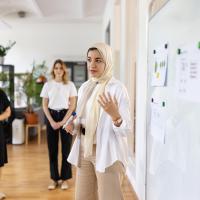 Woman gives presentation to colleagues