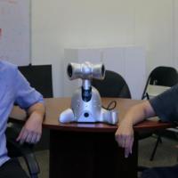 <p>Gil Weinberg and Richard Savery pose with a Shimi robot, one of the robots created by the Robotic Musicianship group.</p>