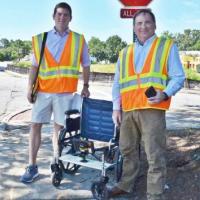 <p>GT Professor Randal Guensler and grad student Daniel Walls demonstrating their wheelchair based sidewalk survey rig.</p>