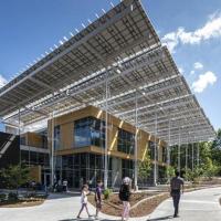 <p>The Kendeda Building for Innovative Sustainable Design features a large "front porch" shaded by some of the hundreds of solar panels that generate electricity for the building. (Photo: Justin Chan Photography)</p>