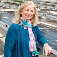 Regents' Professor Marilyn Brown stands among solar panels