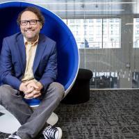 Michael Best, executive director of the Institute for People and Technology, seated in a round chair.